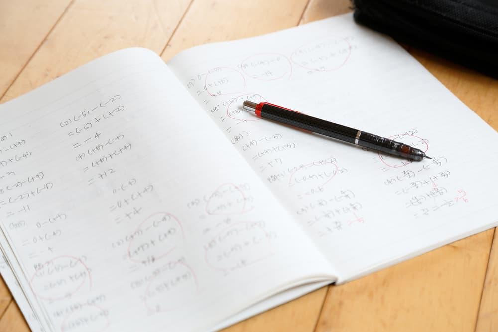 Math notebook filled with integer operation problems.