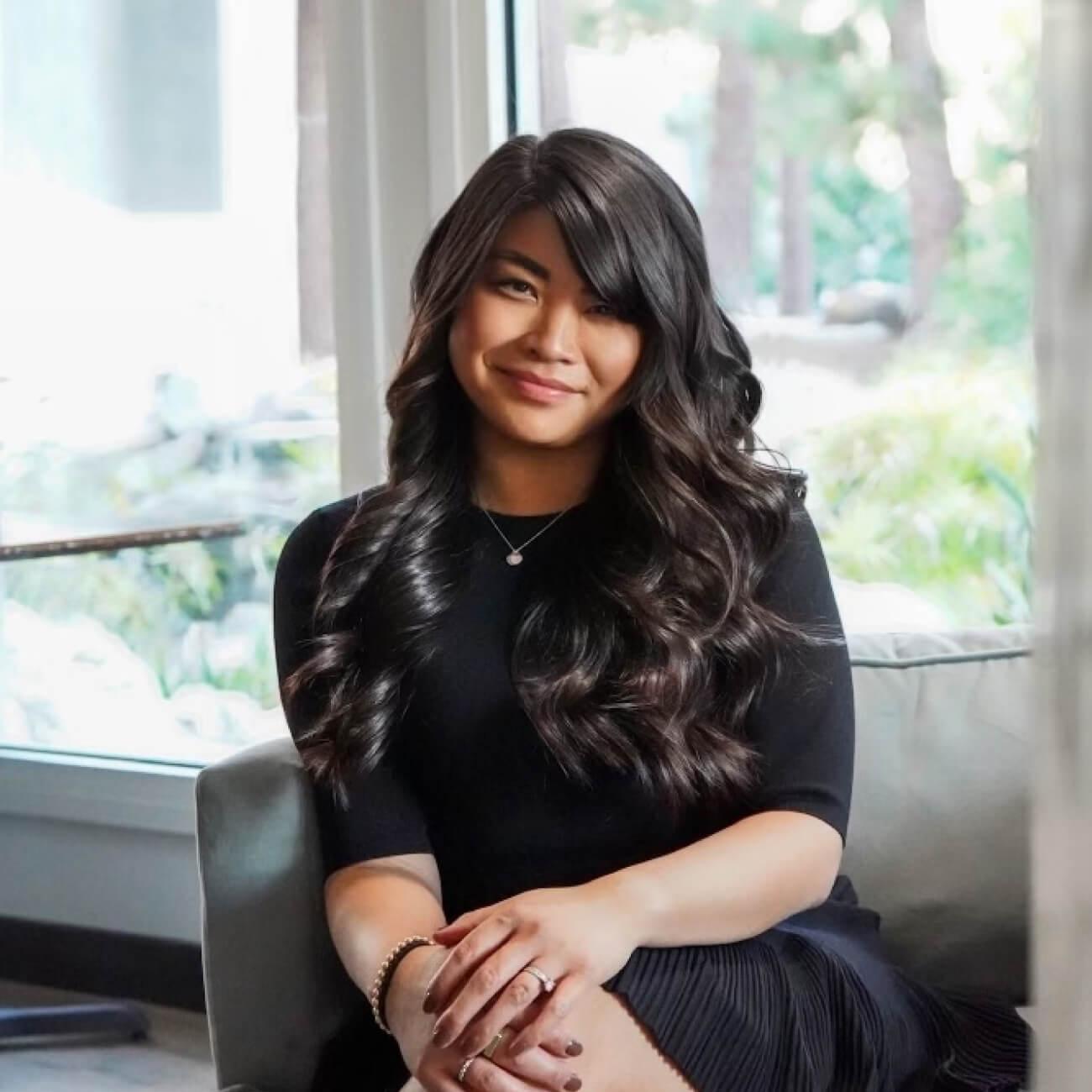Jaime Luu sitting on a couch.